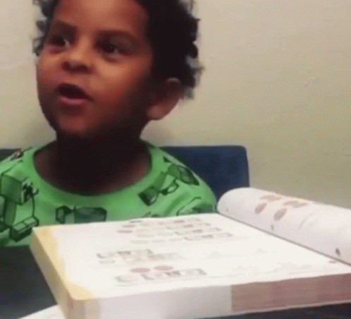 Boy In Green Shirt Reading Book GIF