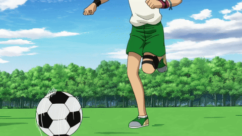 Boy in Green Shorts Kicking Soccer Ball