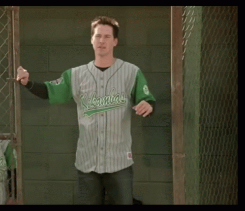 Boy in Green White Baseball Uniform Holding Bat