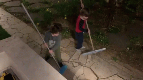 Boy in Mickey Mouse Shirt Sweeping