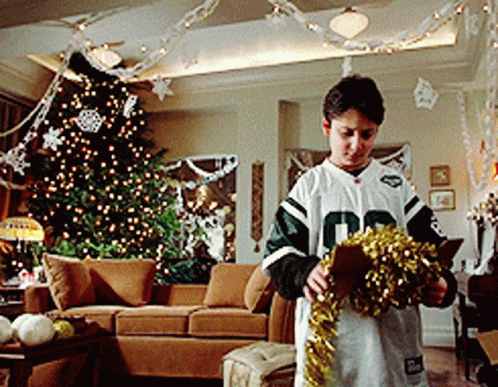Boy In Number 10 Jersey Decorating Christmas Tree GIF