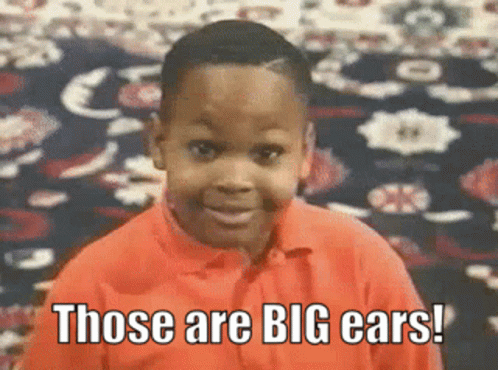 Boy in Orange Shirt Saying Big Ears