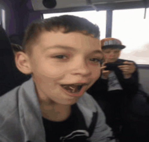 Boy in Oregon Hat Looking at Camera