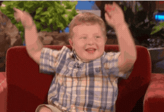Boy in Plaid Shirt Sitting on Couch