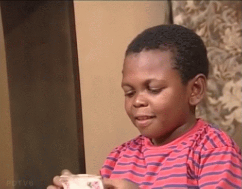 Boy in Red and Purple Striped Shirt Holding Milk