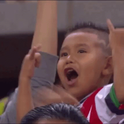 Boy in Red and White Striped Shirt Raising Hands