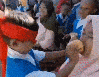 Boy in Red Hat and Blue Shirt Eating Hamburger