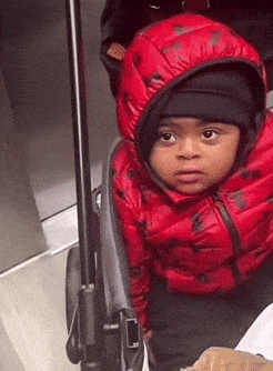 Boy in Red Jacket and Black Hat in Stroller