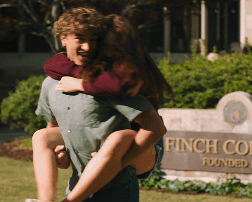 Boy in Red Vest and Plaid Shirt Holding Backpack