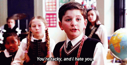 Boy in School Uniform Talking to Children