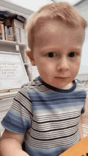 Boy in Striped Shirt Making Funny Face