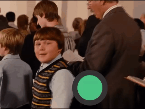 Boy in Striped Vest in Crowd With Green Circle