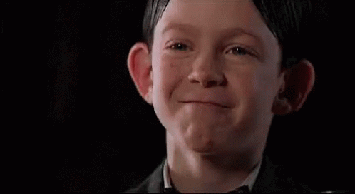Boy in Suit and Bow Tie Making Face