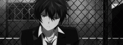 Boy In Suit Sitting In Front Of Fence GIF