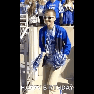 Boy in Sunglasses and Blue Jacket Holding Pom Poms