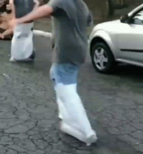 Boy in White Shirt and Black Shorts Walking on Brick Walkway