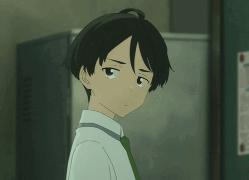 Boy In White Shirt And Green Tie Looking At Camera GIF