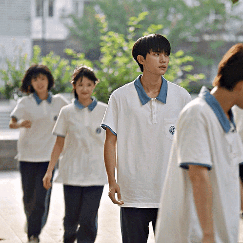 Boy in White Shirt With Blue Collar and Blue Circle
