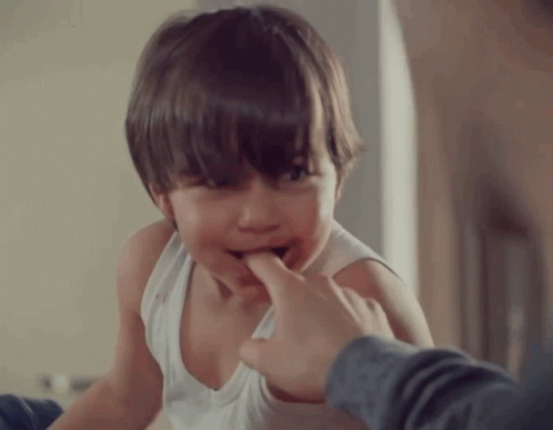 Boy in White Tank Top Biting Finger