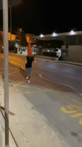 Boy in Witch Hat Amid Traffic Cones Saying Meanwhile at My House