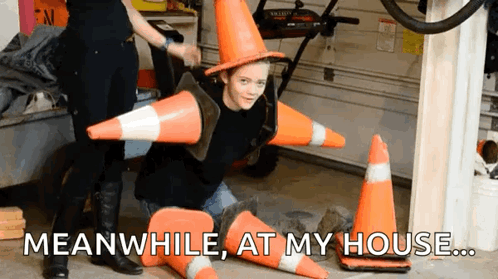 Boy in Witch Hat Surrounded by Traffic Cones Meanwhile at My House
