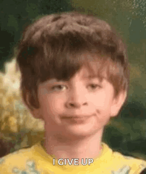 Boy in Yellow Shirt Smiling and Making a Face