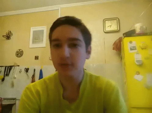 Boy In Yellow Shirt, Yellow Refrigerator, And Clock
