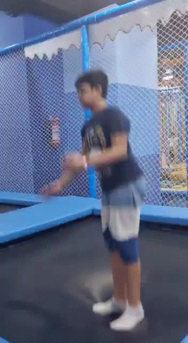 Boy Jumping on Trampoline in Playground