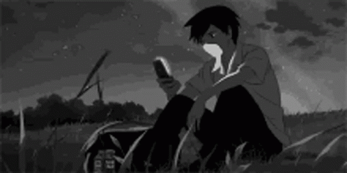 Boy Looking At Phone In Grass GIF