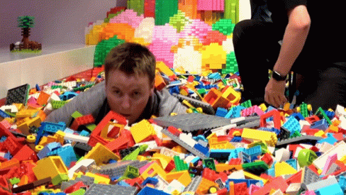 Boy Lying in Lego Bricks