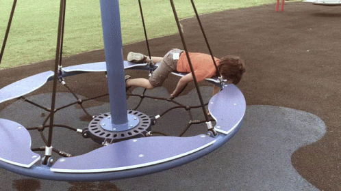 Boy Lying on Blue and Purple Merry Go Round