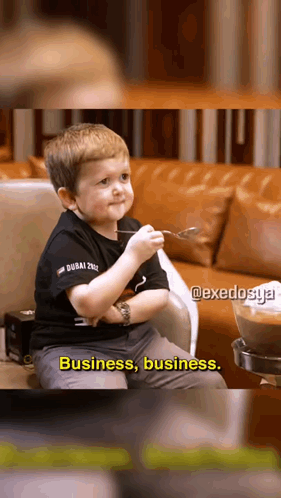 Boy on Couch Holding Spoon Saying Business Business