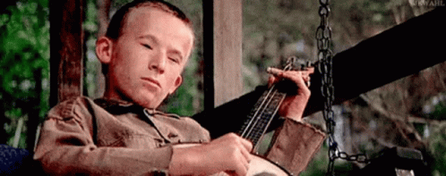 Boy On Porch Swing Playing Banjo GIF