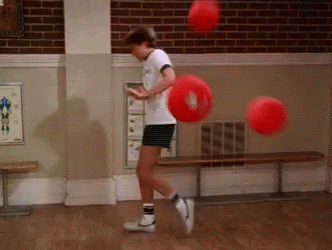 Boy Playing with Red Balls