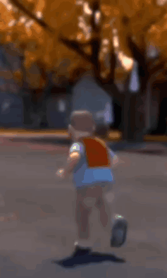 Boy Running Down Street