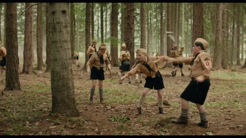Boy Scouts In Woods With O On Uniform GIF