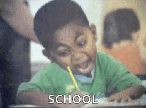 Boy Sitting at Desk with Pencil