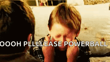 Boy Sitting at Table with Hands on Face