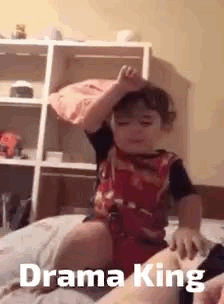 Boy Sitting on Bed with Crown