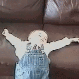 Boy Sitting on Couch with Outstretched Arms