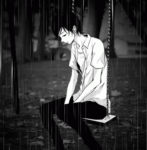 Boy Sitting on Swing in Rain