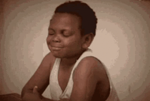 Boy Sitting With Eyes Closed In White Tank Top GIF