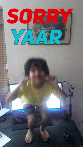 Boy Squatting in Front of Computer Saying Sorry Yaar