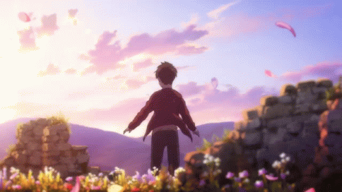 Boy Standing in Field of Flowers With Arms Outstretched