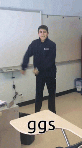 Boy Standing in Front of Whiteboard Saying GGS