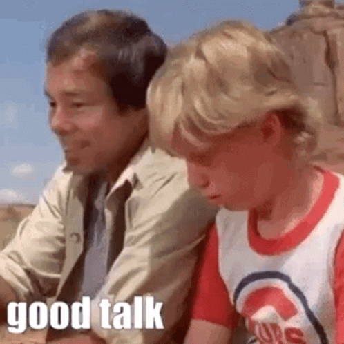 Boy Talking to Seated Man