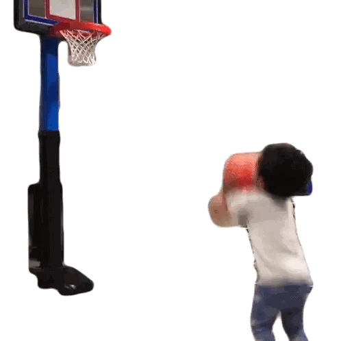 Boy Throwing Basketball Into Hoop