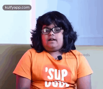 Boy Wearing Glasses and Orange Shirt Saying Sup Dude