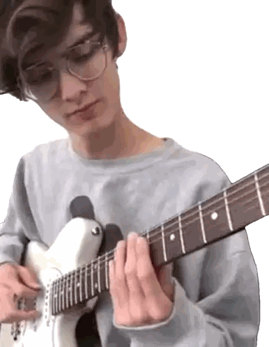 Boy Wearing Glasses Playing Guitar