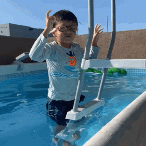 Boy Wearing Glasses Standing in Pool